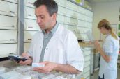 Pharmacist checking medication on electronic device