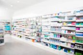 Defocused image of products arranged in shelves at pharmacy