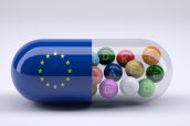 Pill with European flag wrapped around it and colored balls inside, 3d illustration