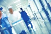 Blurred figures of walking medical staff in the hospital hallway