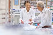 Shot of a young pharmacist helping an elderly customer at the prescription counter