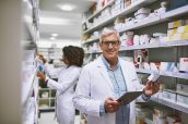 Whats on the menu today. Portrait of a cheerful mature male pharmacist holding a digital tablet and box of meds while looking at the camera