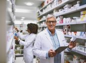 Whats on the menu today. Portrait of a cheerful mature male pharmacist holding a digital tablet and box of meds while looking at the camera
