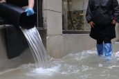 high water in Venice in Italy and people emptying the water from