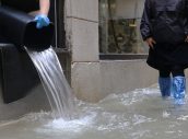 high water in Venice in Italy and people emptying the water from