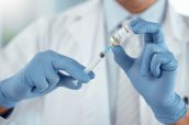 Healthcare, vaccine and closeup of a doctor with a needle with covid, sick or allergy treatment. Professional, injection vial and hands of male medical worker with a vaccination syringe in a hospital.