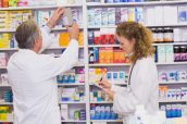 Pharmacists searching medicines with prescription at hospital pharmacy